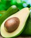 Avocado fruits on the old wooden table.
